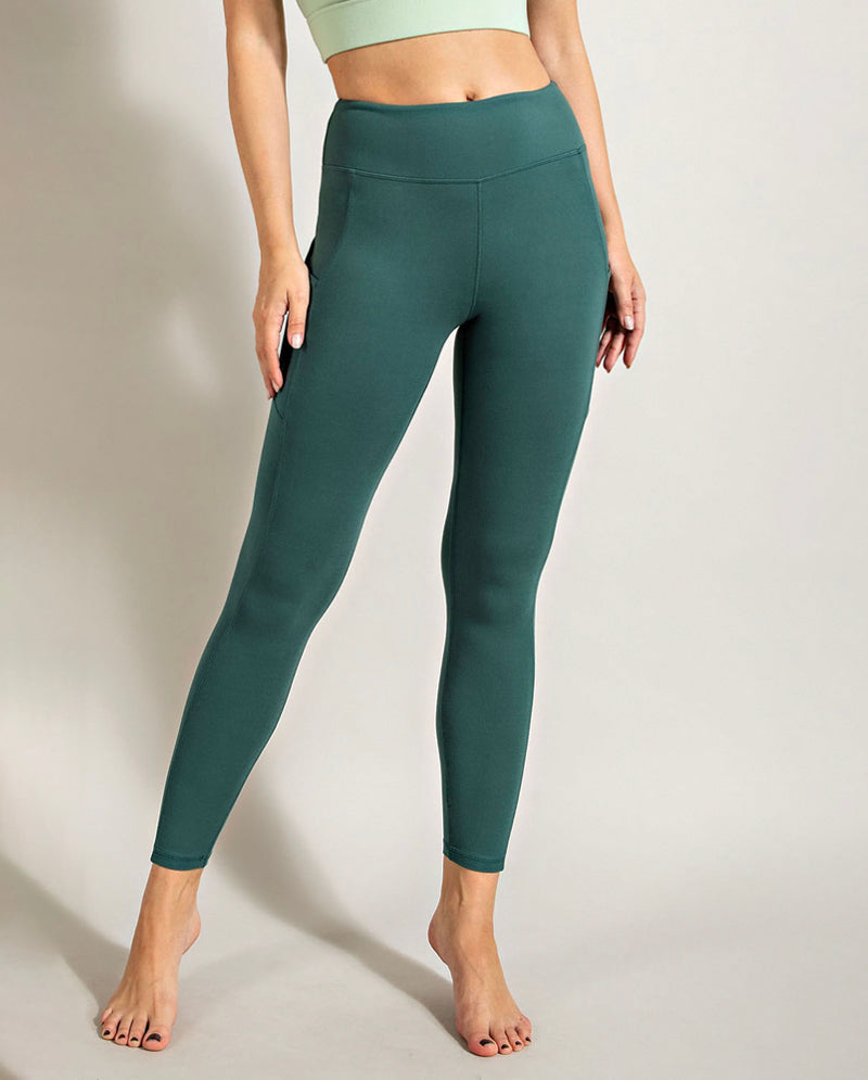 greenish teal leggings side pockets modeled on a - Depop